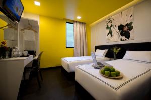 Postel nebo postele na pokoji v ubytování Venue Hotel