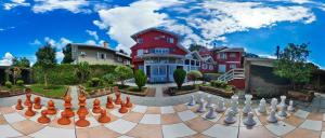 a large chess board in front of a house at Aardvark Inn Pousada in Gramado