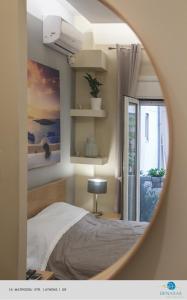 Una cama o camas en una habitación de Denaxas Apartments in the heart of Athens