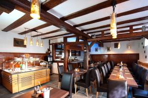 a dining room with wooden tables and chairs at Hotel Blüchertal in Bacharach