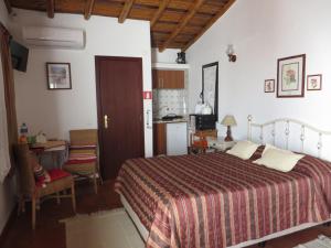 a bedroom with a large bed and a kitchen at Villa El Alcazar in Carvoeiro +59 photos