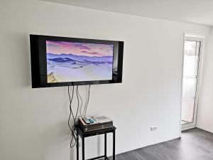 a flat screen tv hanging on a wall at Business Apartment VAT Invoice Near Metro in Munich
