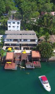 an aerial view of a building with a boat in the water at Porto Dourado, G2 in Angra dos Reis