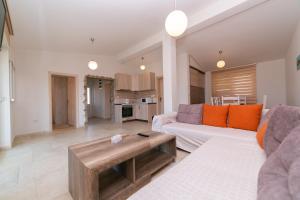 a living room with a couch and a table at Apartmani Tripović in Tivat