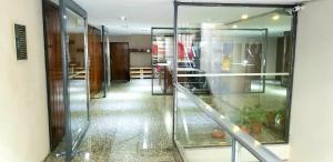 an empty hallway with glass walls and a staircase at Studio Harrods in Buenos Aires