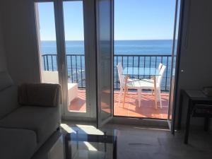 a living room with a table and a view of the ocean at Balcon Del Mar Primera Linea de Playa in La Cala de Mijas