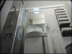 a bathroom with a sink and a shower and towels at Mamut Stay in Kamnik