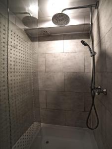 a bathroom with a shower with a shower head at Beautiful DutchHouse Centrum in Amsterdam