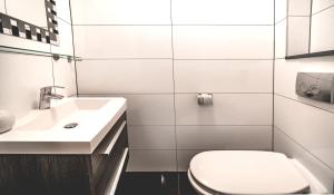 a white bathroom with a toilet and a sink at Beautiful DutchHouse Centrum in Amsterdam