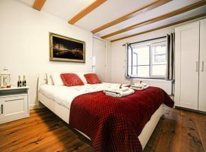 een slaapkamer met een bed met een rode deken bij Beautiful DutchHouse Centrum in Amsterdam