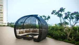 a wicker swing sitting on top of a balcony at V Hotel Lavender in Singapore