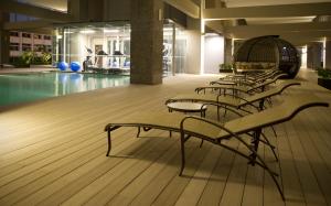 a row of chairs in a pool in a building at V Hotel Lavender in Singapore