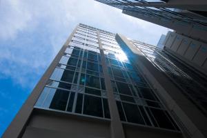 a tall building with the sun shining through the windows at V Hotel Lavender in Singapore