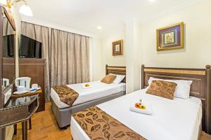 Postel nebo postele na pokoji v ubytování Hotel 81 Chinatown