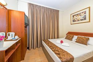 a hotel room with a large bed and a large window at Hotel 81 Geylang - SG Clean in Singapore