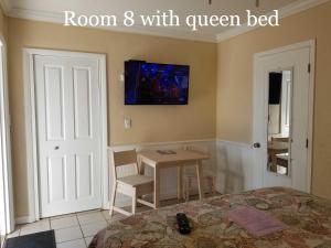 a bedroom with a bed and a television at Haley's at Anna Maria Island Inn in Holmes Beach