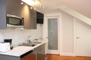 a kitchen with a sink and a microwave at Downtown Beacon Hill, Convenient, Comfy Studio #14 in Boston