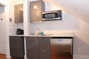 a kitchen with a microwave and a sink at Charming & Stylish Studio on Beacon Hill #15 in Boston