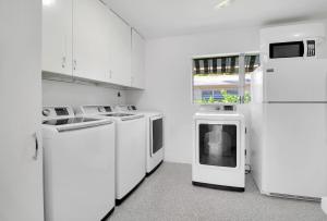 a laundry room with white appliances and a window at The Gondolier Inn in Naples