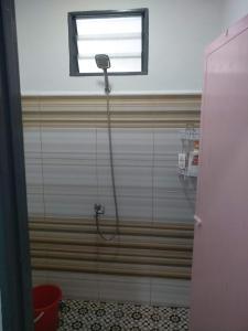 y baño con ducha y ventana. en Anis Homestay Kuala Perlis, en Kuala Perlis