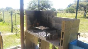 a concrete structure with a grill in a field at Cabañas Aires de Campos in Colón