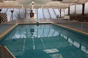 a swimming pool with water in a building at Solar Do Areal in Braga