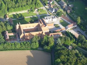 an aerial view of a large building with a lake at Abbaye de Belval in Troisvaux