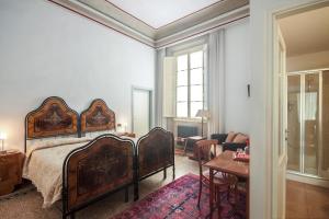 a bedroom with a large bed and a living room at Casa Rovai Guest House in Florence