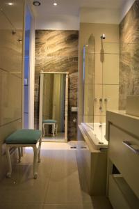 a bathroom with a shower and a bench and a sink at La Casa de Lola BA in Buenos Aires