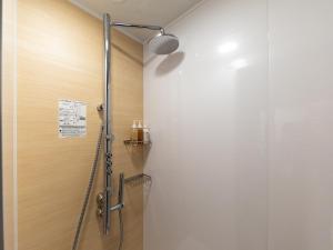 a shower in a bathroom with a glass door at Nishitetsu Hotel Croom Nagoya in Nagoya