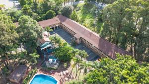 an overhead view of a house with a swimming pool at Country 2 Coast Motor Inn Coffs Harbour in Coffs Harbour