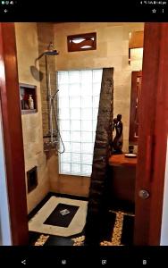 a bathroom with a shower and a toilet and a sink at Gili T Sugar Shack in Gili Trawangan