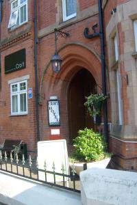 a building with a clock on the front of it at Croft Hotel in Leicester