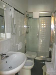 a bathroom with a sink and a toilet and a shower at Hotel Silvestrino in Stintino