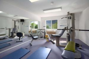 a gym with treadmills and exercise equipment in a room at Super 8 by Wyndham West Kelowna BC in West Kelowna