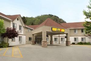 a hotel with a colgate sign in a parking lot at Super 8 by Wyndham West Kelowna BC in West Kelowna