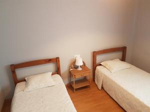two beds in a room with a side table at VILLA FLOR in Cambrils +59 photos