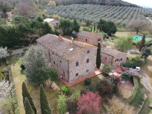 an aerial view of a large stone house with a yard at Podere Il Tigliolo in Castiglione dʼOrcia