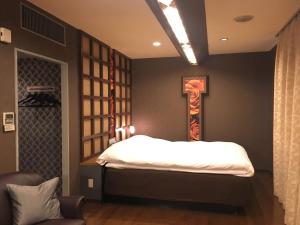 Tempat tidur dalam kamar di Hotel Water Gate Ichinomiya (Adult Only)