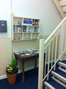 a small table in a room next to a staircase at Royal Chambers Liverpool in Liverpool