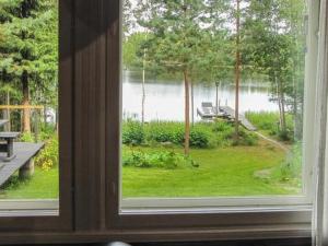 a window looking out at a view of a lake at Holiday Home Lokki by Interhome in Vesijako