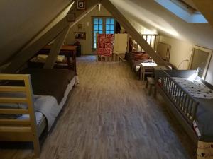 a attic room with bunk beds and a staircase at aux coeurs de l'atelier in Menars