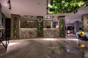 a lobby with plants on the walls at Tourist Hotel in Antalya