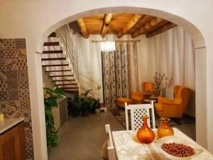 a living room with a table with orange vases on it at B&B Libertà Marsala in Marsala