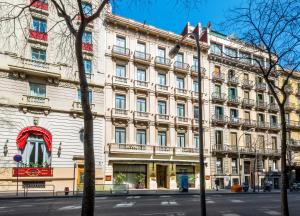a large white building with a red window at Hotel Roger de Llúria in Barcelona