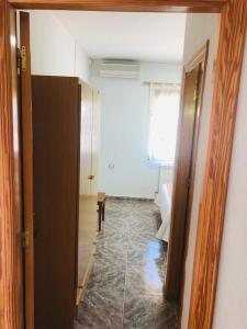 a room with a hallway with a door and a window at Hostal Restaurante Taibilla in Nerpio