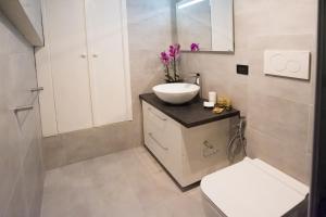 une salle de bain avec un lavabo blanc et des toilettes dans l'établissement Erida Apartment Spanish Steps, à Rome 35 autres photos
