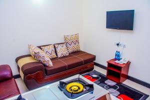 a living room with a couch and a television at Sheratton Regency Hotel in Mombasa