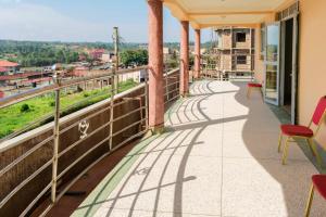 a balcony with chairs and a view of a city at Cityview Hotel Fort Portal in Fort Portal