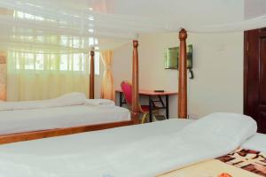Ένα ή περισσότερα κρεβάτια σε δωμάτιο στο Cityview Hotel Fort Portal